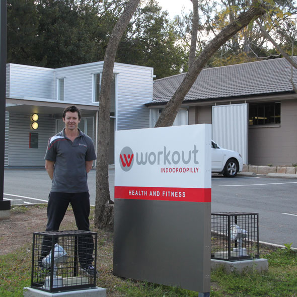 Man standing next to sign