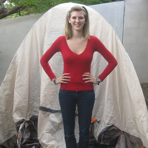 Girls standing next to tent