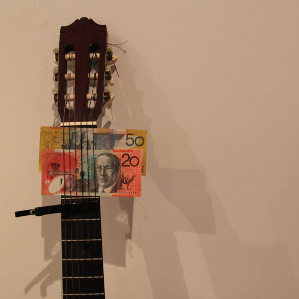 Guitar with money in the neck