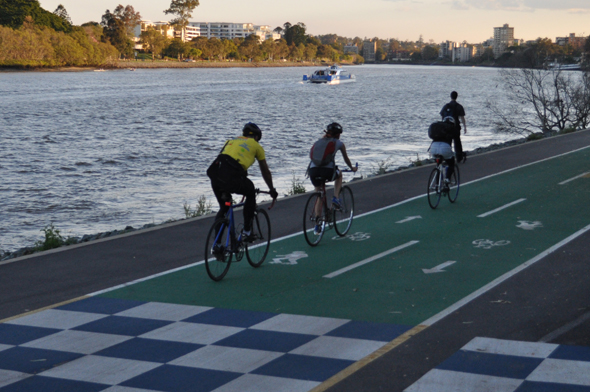 Bike riders on riverside bike path