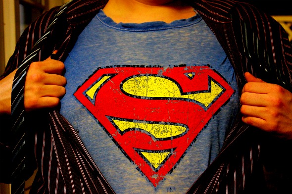 Average man ripping of shirt to reveal superman logo