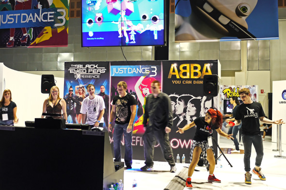 Gaming enthusiasts trying out a dance game at the EB Expo 2011