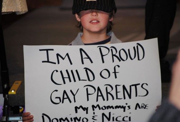 Child of a same-sex couple protesting for same-sex surrogacy.