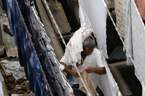 A man hangs out laundry in Dhobi Ghat, Mumbai's largest open-air laundromat. 