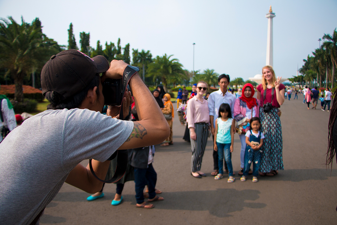 Locals at the National Monument in Jakarta snapping pictures with UQ students. Credit: Elora Ghea.