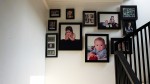 Photos of Evi and Adam displayed above the stairs.