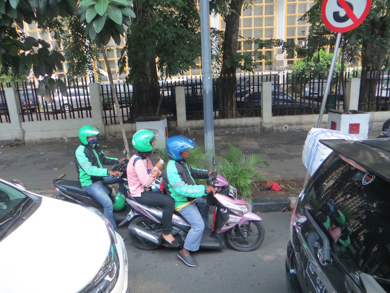 Local Indonesian woman rides Go-Jek in Jakarta