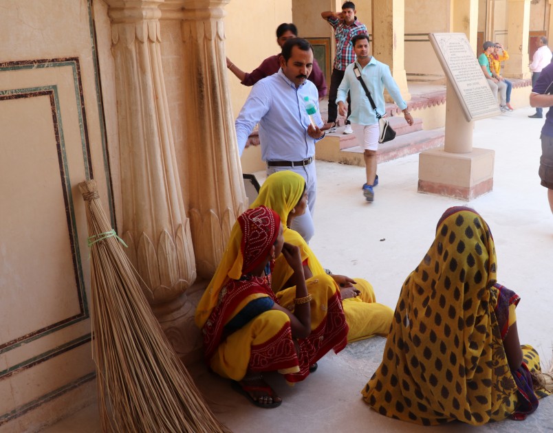 Devendra Singh Rathore speaking with female employees at the Amber fort