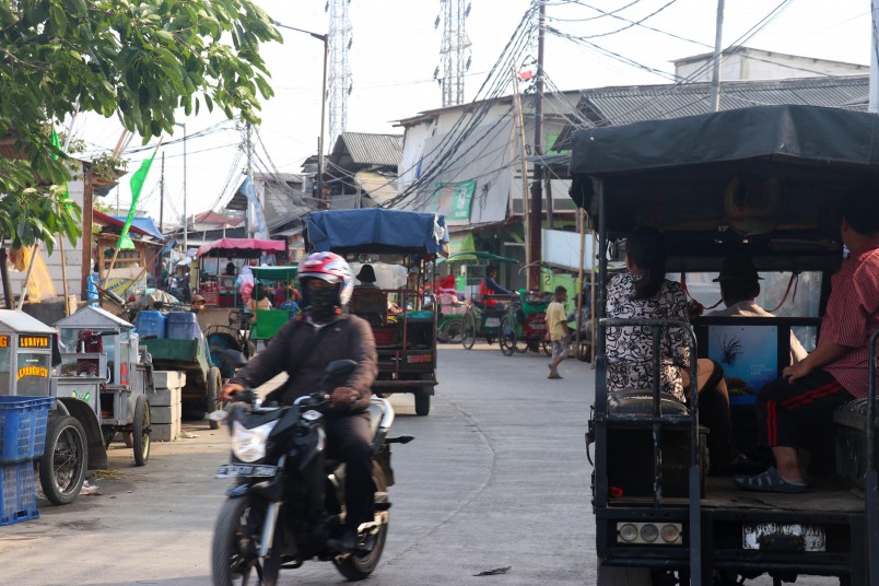 In the wider streets of Muara Angke the traffic noise is incredible